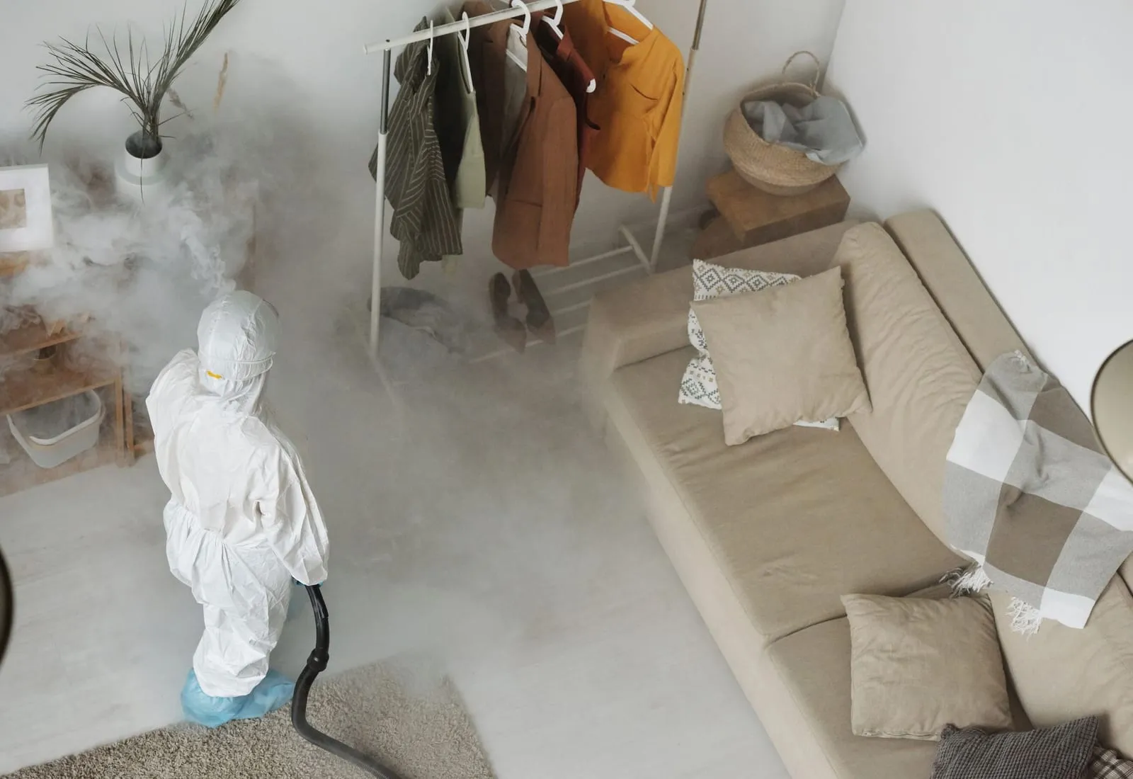 Pest technician treating a living room